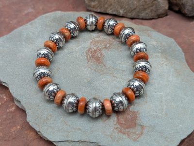 Sterling Silver and Orange Apple Coral stretch bracelet by Laura Ingalls