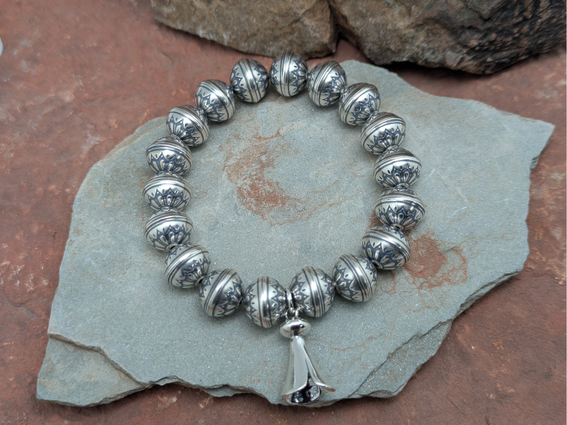 Sterling silver stretch bead bracelet.  Southwestern style.  Squash blossom charm