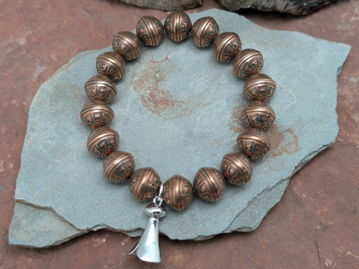Copper bead stretch bracelet with sterling silver squash blossom by Laura Ingalls