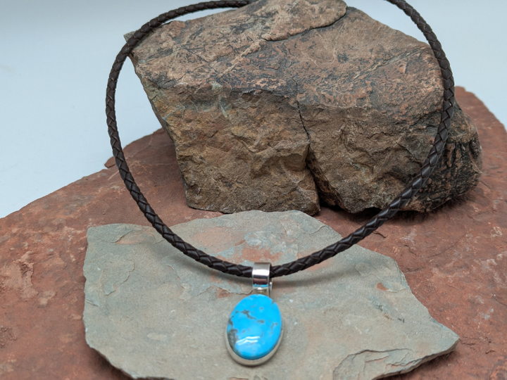Turquoise and Sterling Silver Pendant Necklace. Brown braided leather necklace with lobster clasp